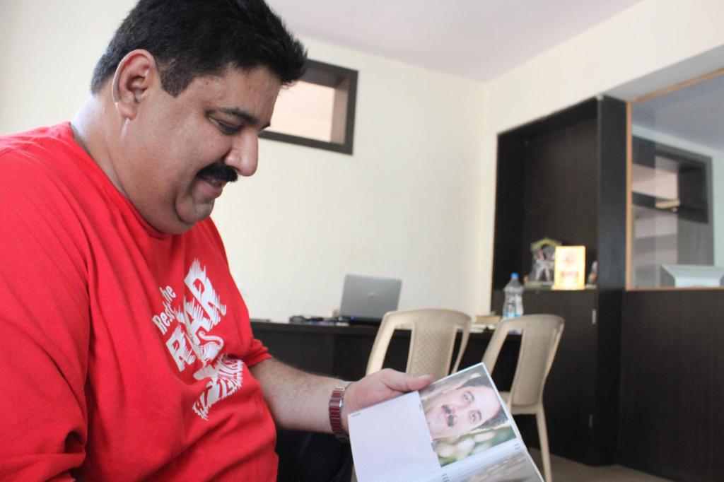 Manoj looks through old memories from his training days at the office of Steve's gym. Photo by Sonia Paul.